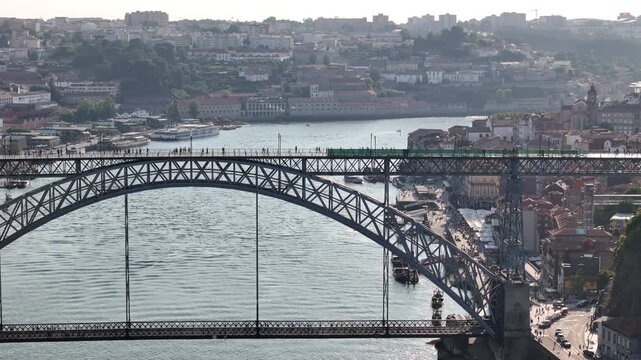 Aerial view of the iconic Luis I Bridge spanning the Douro River with historic city buildings and urban architecture in Porto, Porto District, Portugal.