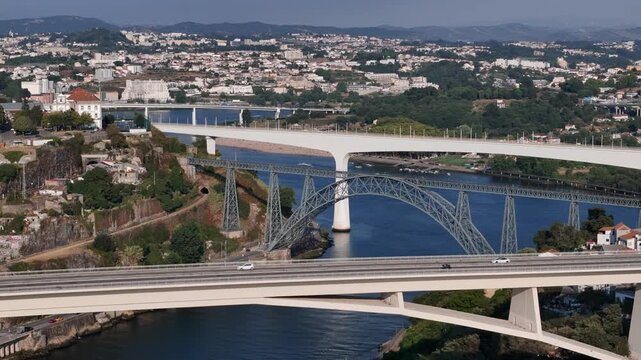 Aerial view of the Ponte Infante Dom Henrique bridge spanning the Douro River with urban architecture in Vila Nova de Gaia, Porto, Portugal.
