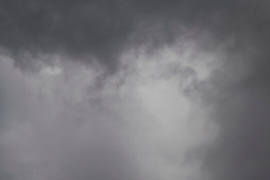 piece of more light cloud framed with darker clouds