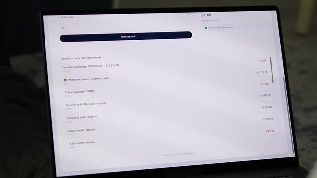 Detailed financial audit on a laptop. Scrolling through recent account activity, including a welcome bonus, and verifying a completed wire transfer with full transaction ID. Ideal for accounting softw