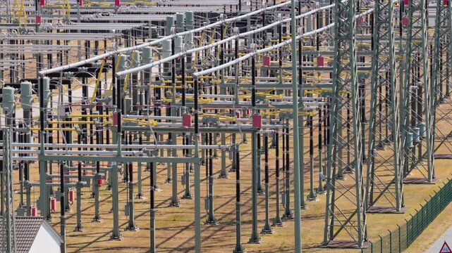 Aerial view of the Amprion-Umspannwerk electrical substation with high-voltage power lines and steel lattice towers in Pfungstadt, Hessen, Germany.