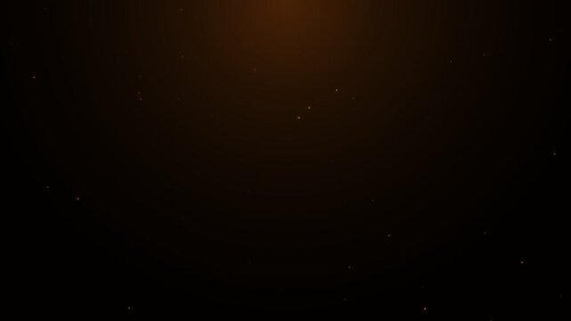 Golden dust particles floating in dark background