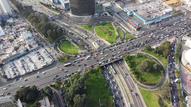 Aerial view of the busy Avenida Javier Prado Este highway interchange with heavy traffic and surrounding green spaces in San Isidro, Lima Province, Peru.