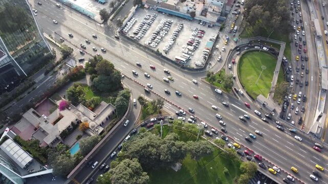 Aerial view of Avenida Javier Prado Este with heavy traffic flow, surrounding office buildings, parking lots, and green spaces in San Isidro, Lima Province, Peru.
