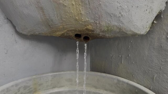 Water drips from the concrete funnel filter