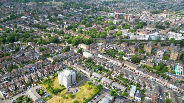 Aerial view of Peckham, showing dense residential streets, terraced houses, a central apartment block, and a railway line in London, England, United Kingdom.