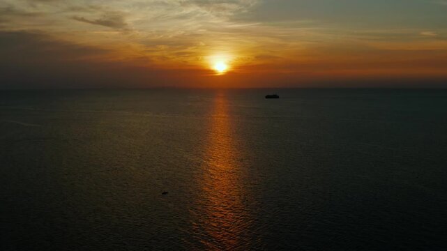 Sunset above the sea surface with waves, aerial view Boracay, Philippines. Reflected sun on a water surface. Sunset over ocean. Seascape, Summer and travel vacation concept