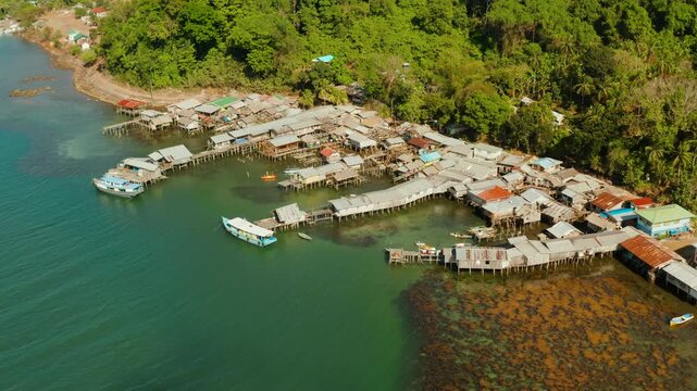 Village of stilt houses built over the sea, top view. City and port on Balabac Island, Palawan, Philippines.