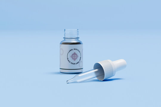 Glass dropper bottle with pipette on blue background