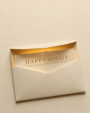 Happy diwali greeting card in open envelope with elegant gold text on textured paper envelope greeting celebration typography invitation religious festival tradition celebrate textured
