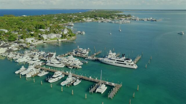 Aerial view of luxury yachts docked at a marina in the turquoise waters of the Caribbean in Dunmore Town, Harbour Island, The Bahamas.