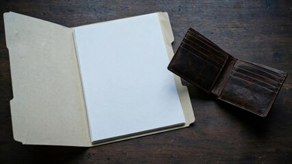 Fototapeta premium Open Notebook and Wallet on Dark Textured Surface.