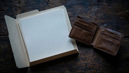 Fototapeta premium Empty Wallet and Open Folder on Dark Wooden Table.