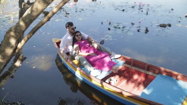 Romantic Couple Enjoying a Boat Ride on a Peaceful Lake During Daytime