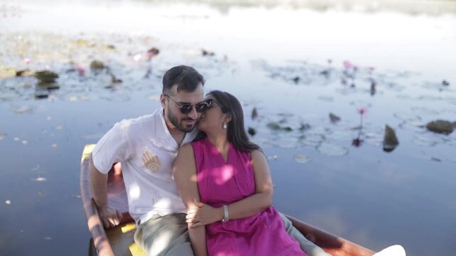Romantic Couple Enjoying a Boat Ride on a Peaceful Lake During Daytime