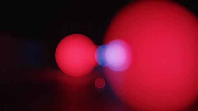 Soft red and blue bokeh orbs creating a dreamlike, ethereal glow