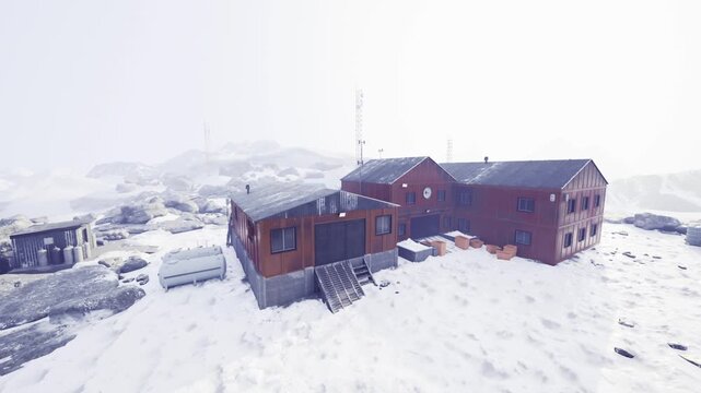 Shelter near antenna. Urgent shelter situated on icy coastal land close to antenna tower equipped with essential supplies and protective structures