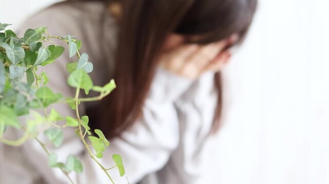 顔を手で覆って深く悲しみ嘆く女性
