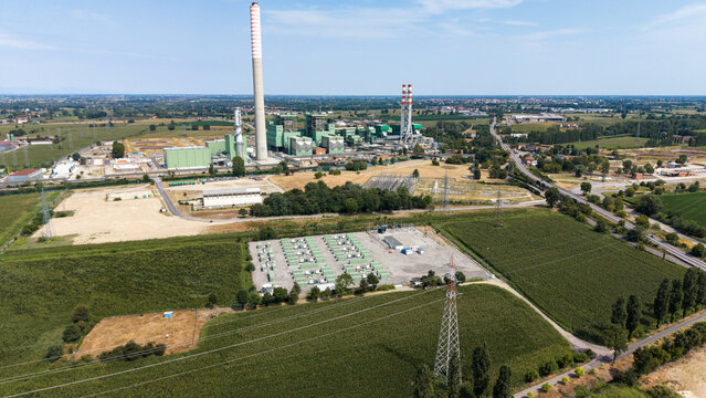 Aerial view of a battery energy storage system facility integrated with a thermal power plant, featuring energy infrastructure in Tavazzano con Villavesco, Lombardy, Italy.
