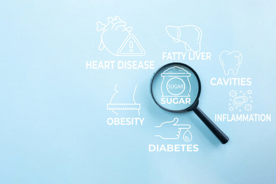 Sugar health risks concept. Magnifying glass focusing on sugar text with icons of diabetes, obesity, heart disease, fatty liver, and cavities on a blue background. Healthcare and diet.