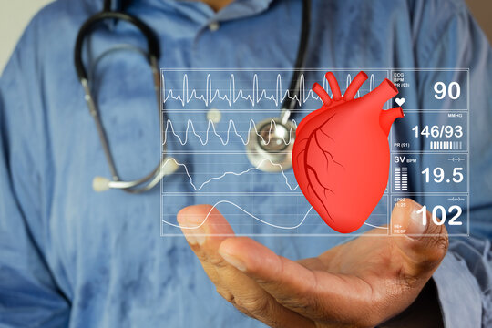 Cardiology and medical technology concept. Doctor holding a digital 3D anatomical heart with futuristic holographic vital signs UI and ECG chart. Telemedicine, healthcare and diagnostics.