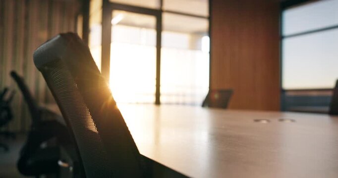 Conference, room and empty office with chairs in corporate building for meeting preparation. Space, equipment or boardroom table with lens flare, windows or sunshine for work seminar or interior