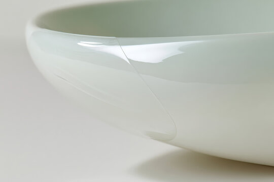 This elegantly designed bowl features a smooth, glossy finish, showcasing modern aesthetics through its refined shape and soft color palette, perfect for any decor.