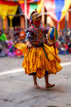 Bhutan, in the village of Bumthang, a monk mask dancer in his colourful costume dances at the festival of Jakar. blurred background