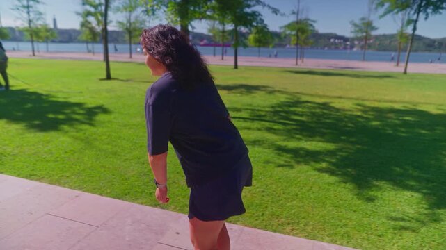 A graceful skater enjoying a sunny day in a vibrant park, showcasing joy and freedom while gliding effortlessly on rollerblades amidst lush greenery.