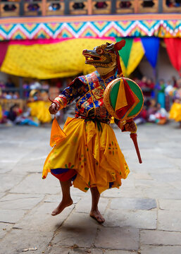 Bhutan, in the village of Bumthang, a monk mask dancer in his colourful costume dances at the festival of Jakar. blurred background