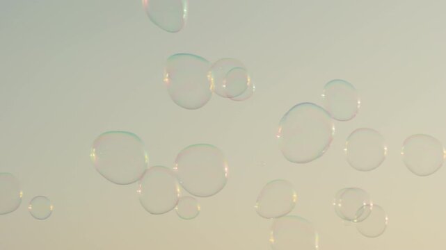 Giant soap bubbles drift through the sky above the waterfront promenade in Zadar Croatia.