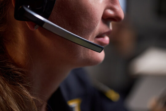 Close up of Caucasian young adult woman wearing headset, speaking during customer support call in office. Ideal for contact center, help desk, service communication marketing