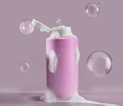 Pink cosmetic bottle with shampoo or shower gel, surrounded by flying bubbles