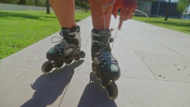 Exciting Roller Skating Adventure: A Close-Up Look at the Art of Lacing Up and Preparing for an Energetic Session on Inline Skates in the Sunshine
