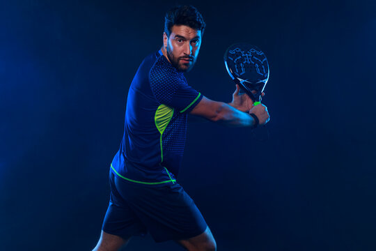 Padel Tennis Player with Racket in Hand. Paddle tenis, on a blue background. Download in high resolution.