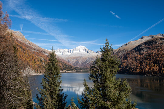 Scenic view of Lake Malga with Mount Car&egrave; Alto under bright sunshine in Val San Valentino, Italy.