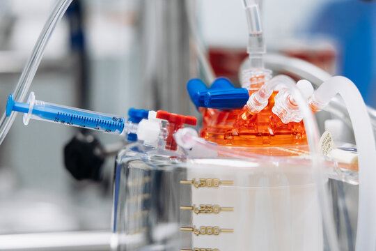 Close-up of an oxygenator, blood tubing and connectors of a cardiopulmonary bypass machine.