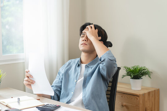 Stressed bankrupt financial crisis concept, Young adult in nervous after calculated loan expense and can not pay to bank.