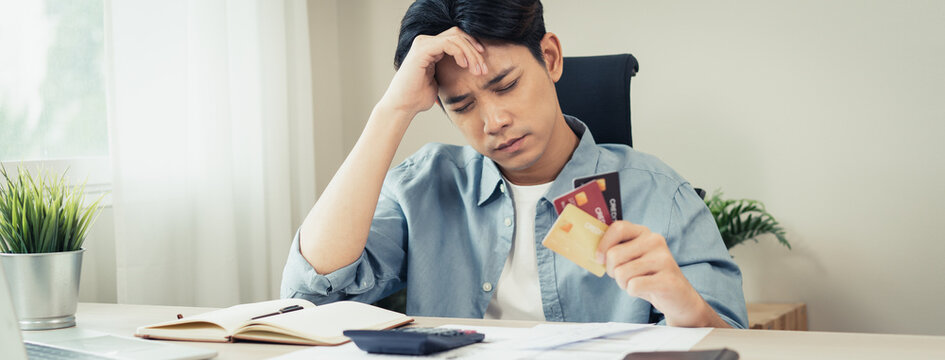 Stressed bankrupt financial crisis concept, Young adult in nervous after calculated loan expense and can not pay to bank.