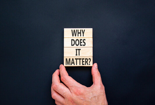 Why does it matter words symbol. Concept words Why does it matter on beautiful wooden blocks. Beautiful black background. Businessman hand. Business support why does it matter concept. Copy space.