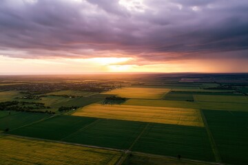 Fototapeta premium The Aerial View of Expansive Farmlands at Sunset, Serene and Bountiful