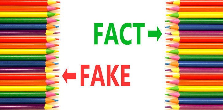 Fact or fake words symbol. Concept words Fake and Fact on beautiful white paper. Beautiful white background. Colored pencils. Business and fact or fake concept. Copy space.