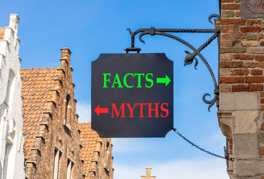 Facts or myths words symbol. Concept words Myths and Facts on beautiful black road sign. Beautiful blue sky and Brugge street background. Business and facts or myths concept. Copy space.