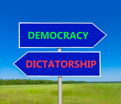 Democracy or dictatorship words symbol. Concept words Democracy Dictatorship on beautiful blue road sign. Beautiful blue sky background. Business democracy dictatorship concept. Copy space
