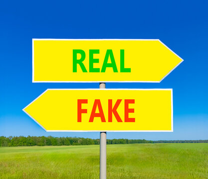 Real or fake words symbol. Concept words Fake and Real on beautiful yellow road sign. Beautiful blue sky background. Business and real or fake concept. Copy space.