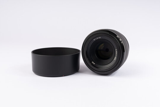 Professional camera lens with hood. Optical equipment for photography and videography.