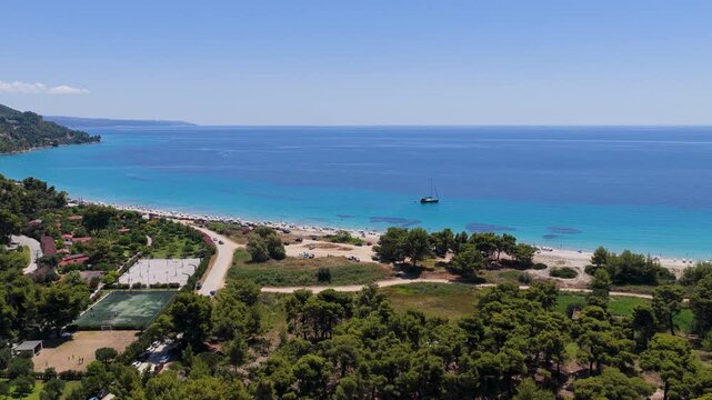 Coastal panorama of Possidi beach with sailboat and blue sea