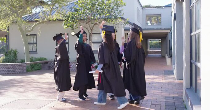 Diverse youth classmates celebrating one running in with diploma highfiving tossing caps on campus