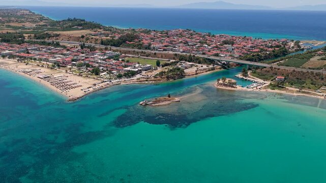 Nea Potidea coastline with turquoise sea and seaside village