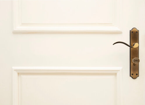 Modern style door handle on white wooden door